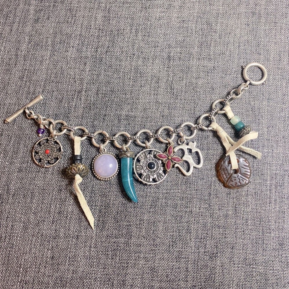 Lucky Brand silver toned toggle bracelet with 9 charms. - Picture 1 of 7